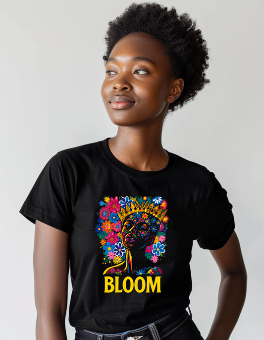 Person wearing a black t-shirt with a colorful graphic and the word 'BLOOM' on a plain background