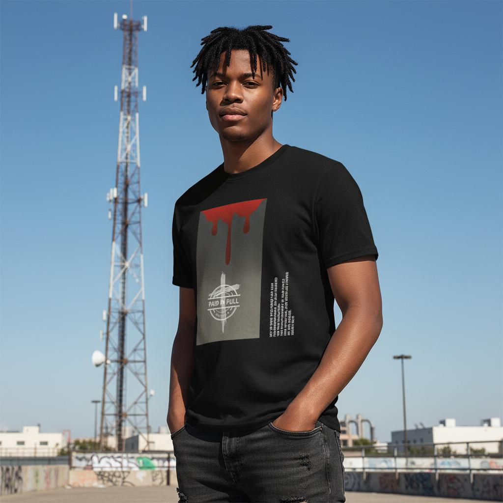 Person wearing a black Paid in Full Isaiah 53 Inspired t-shirt with a graphic design, standing in urban setting
